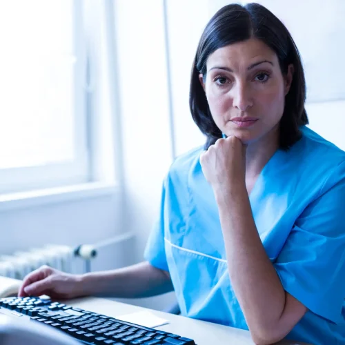 Portrait of doctor sitting in medical office at hospital